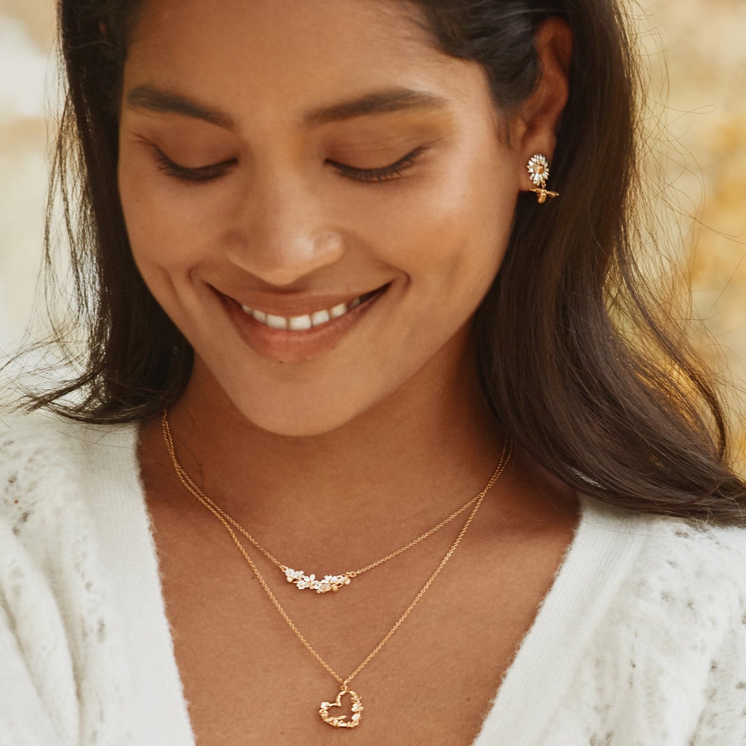 model wearing gold plated Floral Heart Necklace with Itsy Bitsy Bee by Alex Monroe Jewellery