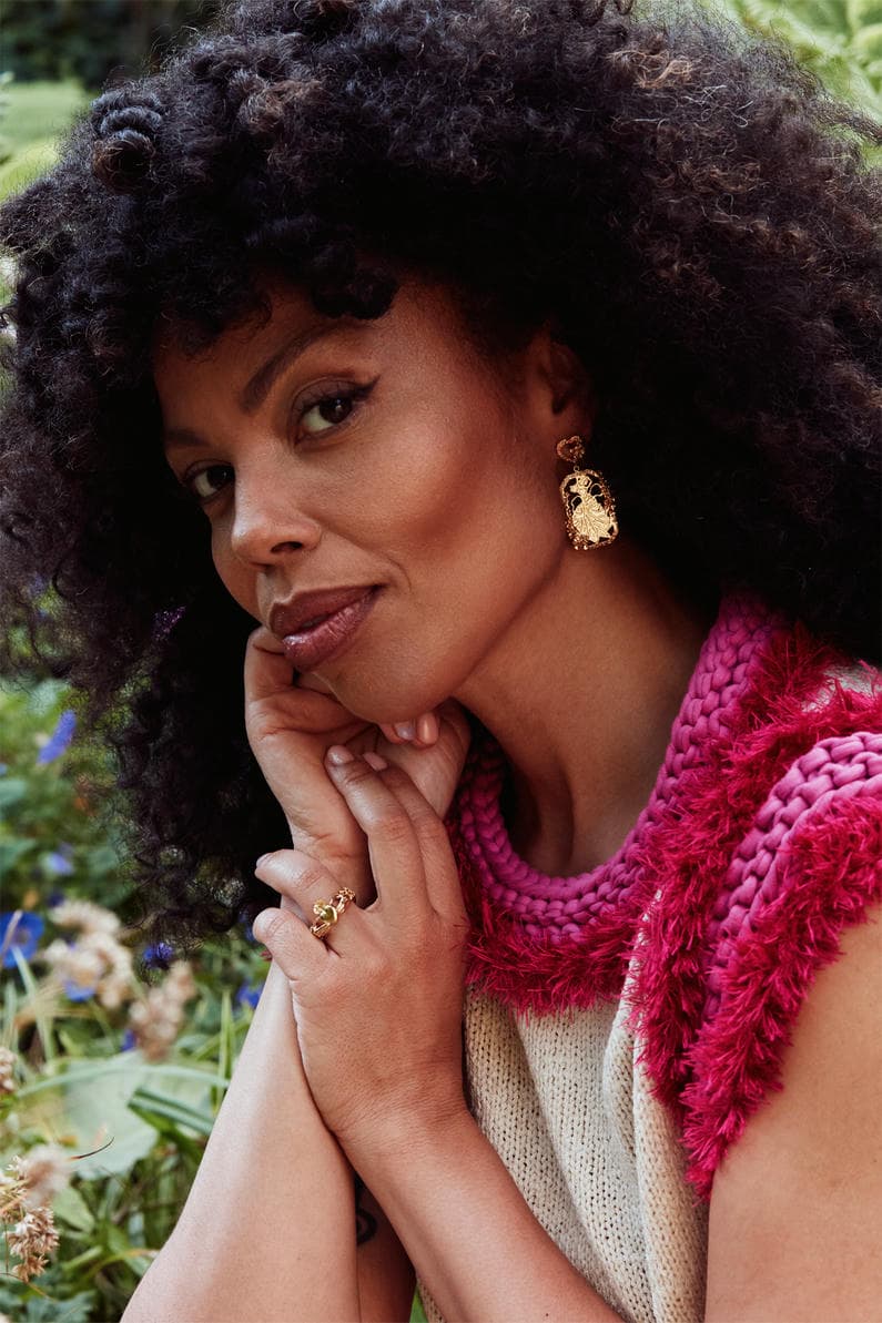 Emma Dabiri wearing statement earrings and Claddagh ring.